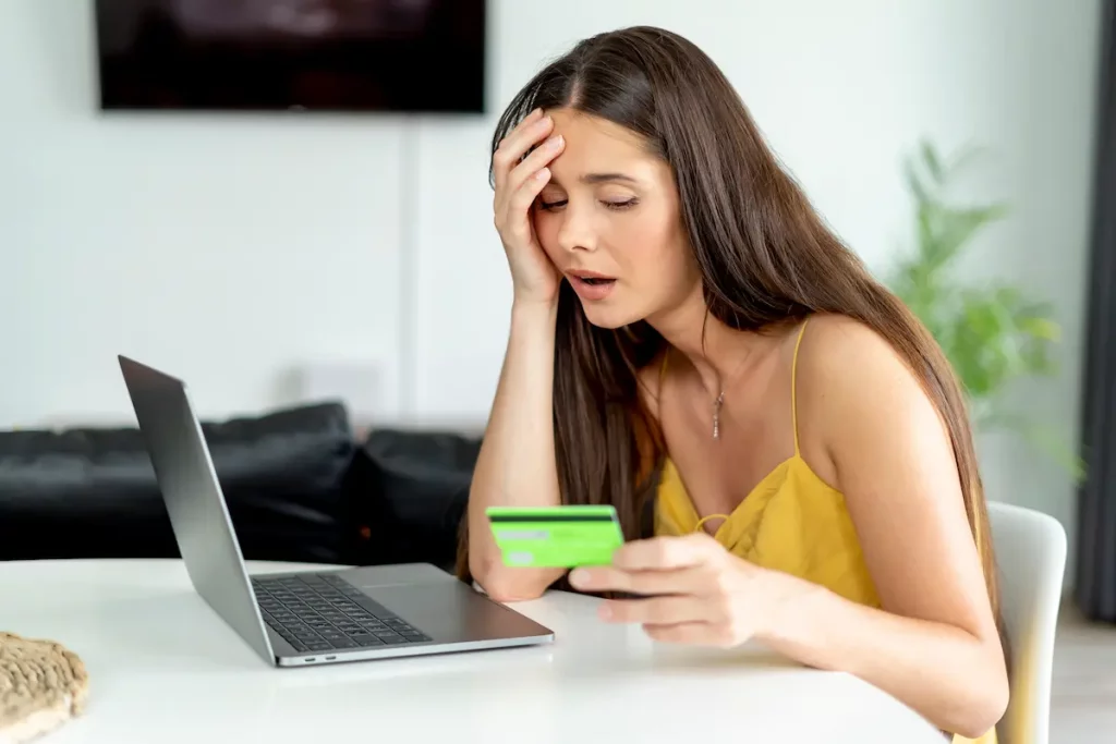 Woman looking sad doing online shopping