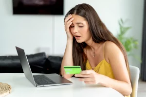 Woman looking sad doing online shopping